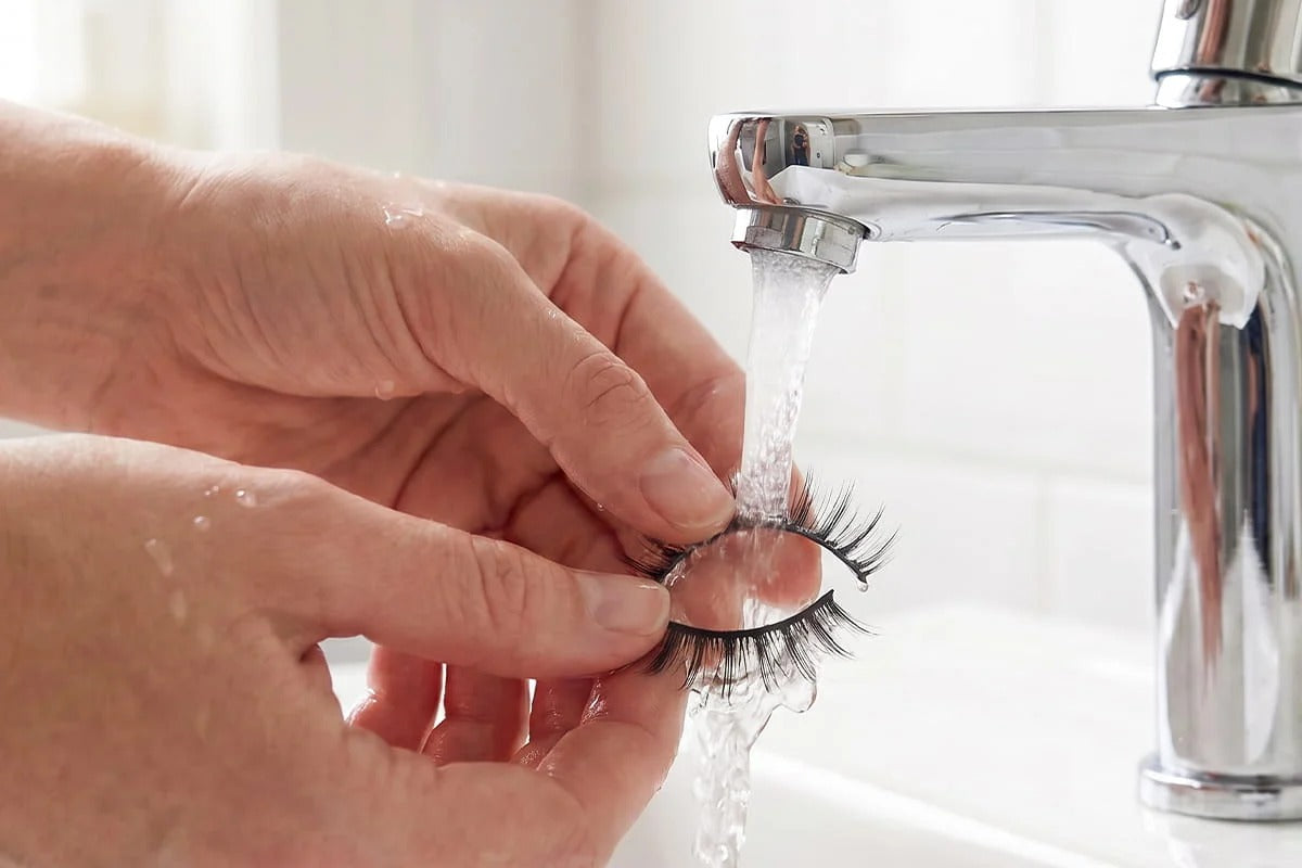 Rinsing reusable false eyelashes under water