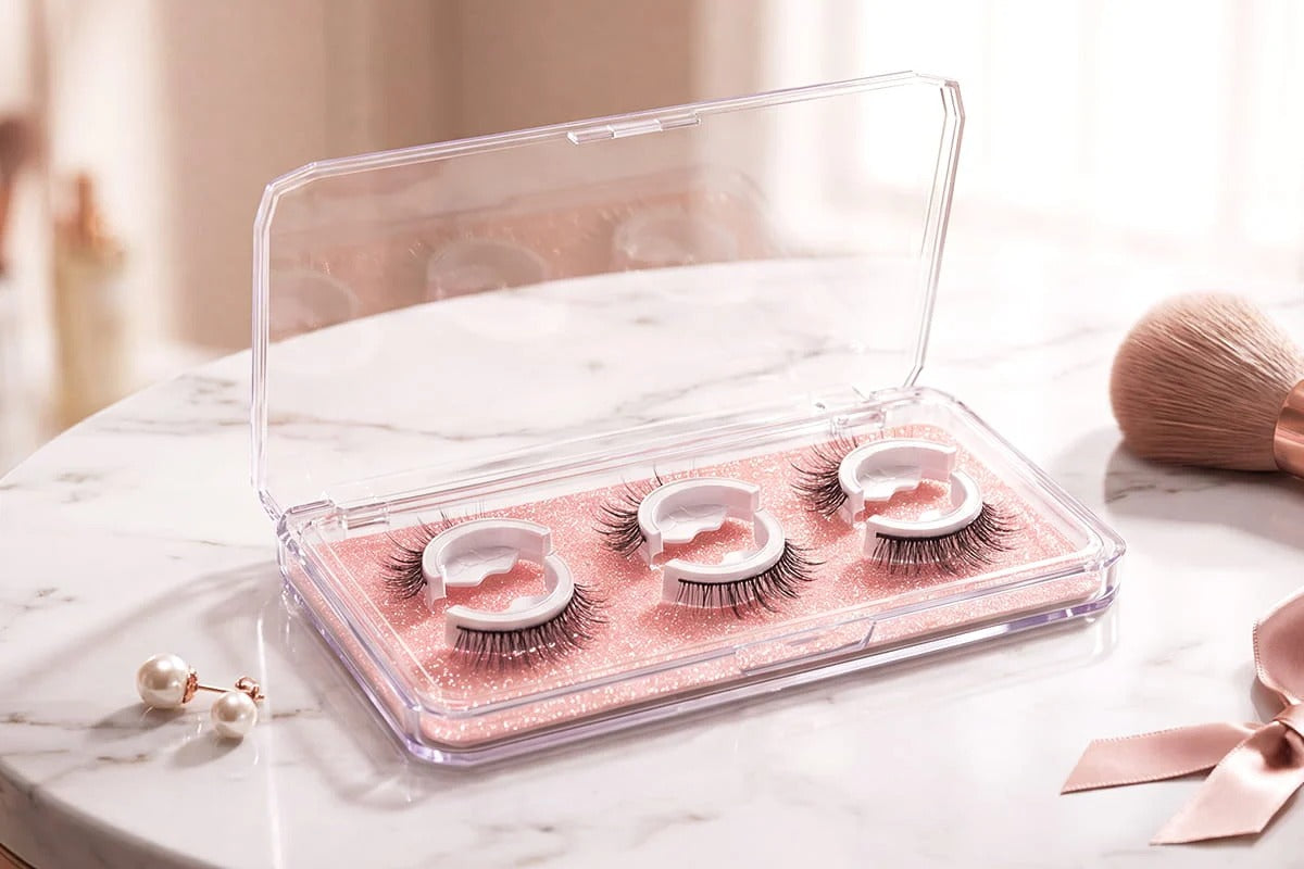 Reusable false eyelashes arranged in a clear storage case